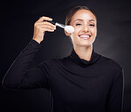 Makeup, brush or portrait of woman in studio with beauty cosmetics or facial foundation products on black background. Makeup artist, smile or happy girl brushes face for luxury skincare grooming 