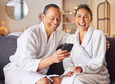 Buy stock photo Phone, spa and relax with a couple in a luxury resort for a weekend getaway of bonding together. Portrait, social media and wellness with a man and woman sitting in a health spa or salon for rest
