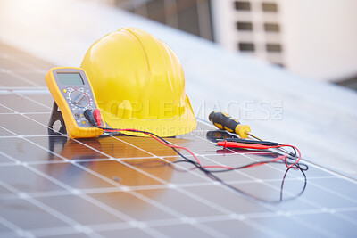 Buy stock photo Tools, solar panels or helmet on roof for solar energy installation in a city development project. Voltmeter, Construction, renewable energy or electric engineering equipment for building maintenance