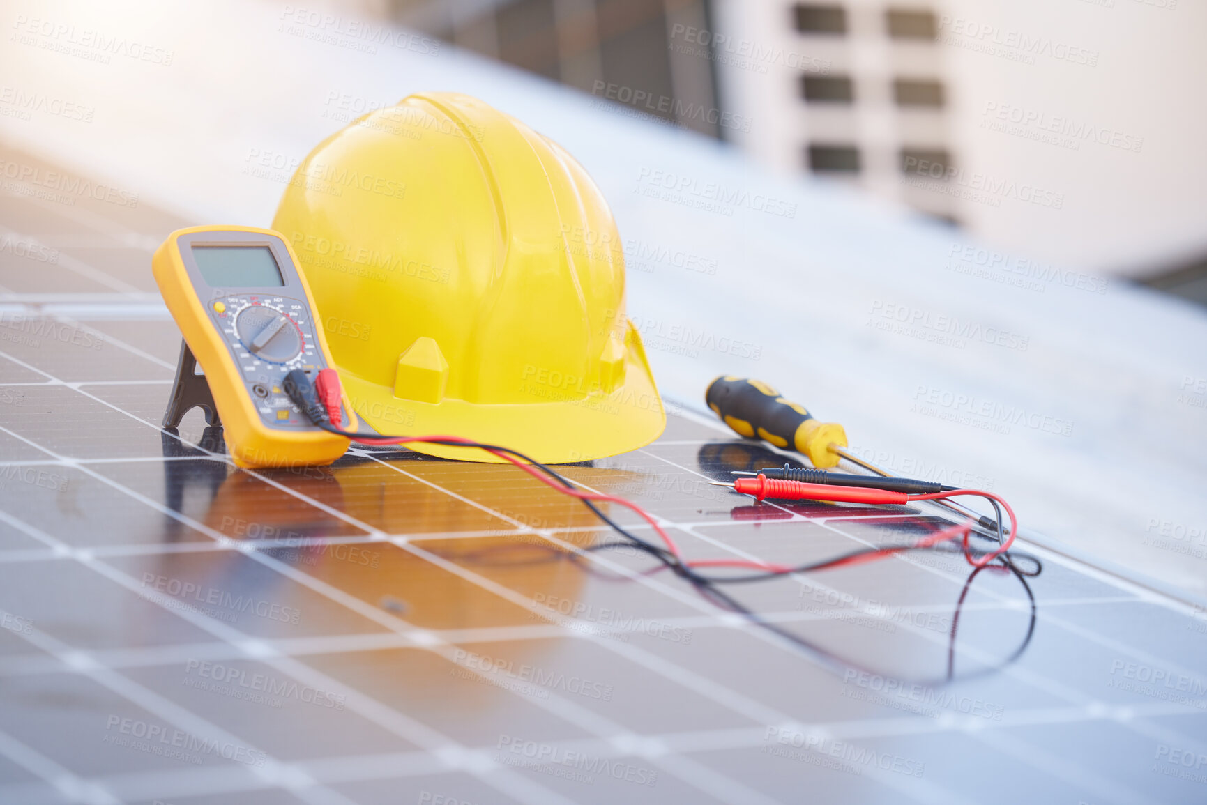 Buy stock photo Tools, solar panels or helmet on roof for solar energy installation in a city development project. Voltmeter, Construction, renewable energy or electric engineering equipment for building maintenance