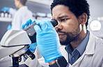 Black man, scientist and microscope with science research in laboratory, data analysis and expert with scientific or medical innovation. Phd doctor, face and biotechnology, chemistry and study in lab