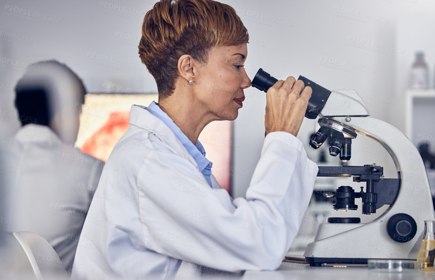 Buy stock photo Science, laboratory and black woman with microscope, research for vaccine development. Healthcare, medical innovation and senior scientist woman in hospital lab looking at pharmaceutical test results