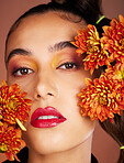 Makeup, beauty or woman in studio with flowers for art fashion and natural facial cosmetics for self care. Face portrait, orange plants or girl model with red lipstick, eyeshadow and glowing skin 