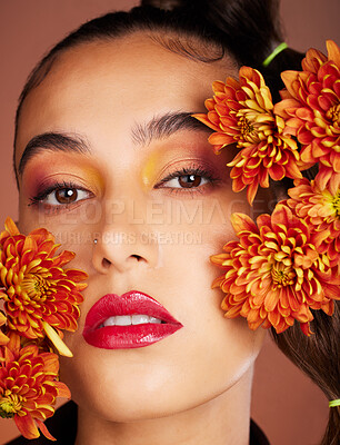 Buy stock photo Makeup, beauty or woman in studio with flowers for art fashion and natural facial cosmetics for self care. Face portrait, orange plants or girl model with red lipstick, eyeshadow and glowing skin 