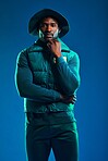 Fashion, style and portrait of black man on blue background with cool, trendy and stylish outfit. Creative, lifestyle clothing and male model pose in studio with designer, modern and edgy clothes