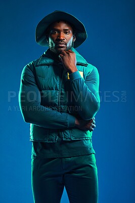 Buy stock photo Fashion, style and portrait of black man on blue background with cool, trendy and stylish outfit. Creative, lifestyle clothing and male model pose in studio with designer, modern and edgy clothes
