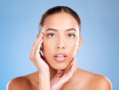 Buy stock photo Face portrait, skincare and beauty of woman in studio on a blue background. Hands, natural cosmetics and makeup of young female model with healthy, smooth and glowing skin after facial treatment.