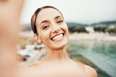 Buy stock photo Selfie, beach and travel with a woman tourist taking a picture outdoor during summer vacation or holiday. Portrait, face and smile with an attractive young female happy on the coast by the sea