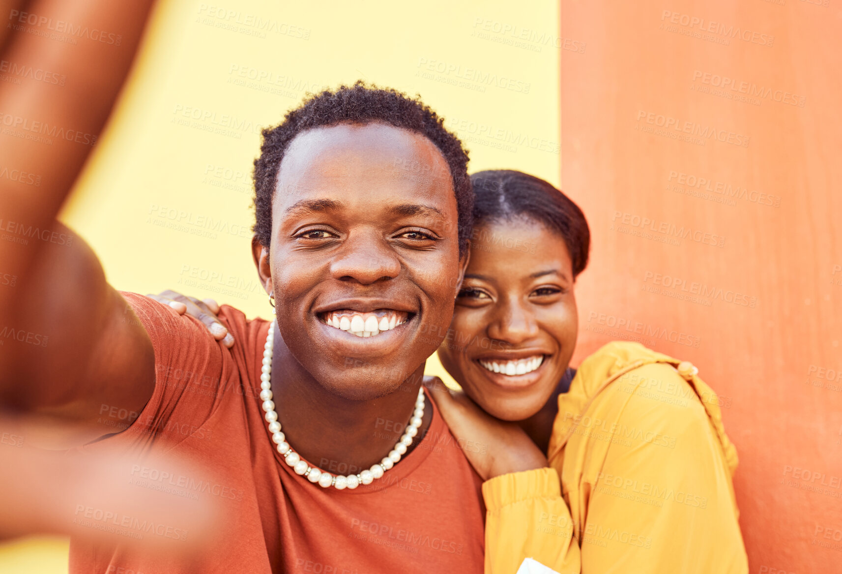 Buy stock photo Selfie, love and memories with a black couple posing for a photograph together on a color wall background. Portrait, happy and smile with a man and woman taking a picture while bonding outside