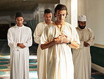 Men, mosque and muslim prayer to Allah for religion, ramadan kareem and worship of arabic culture. Group of people praying with islamic imam to God with holy dua, spiritual focus and peace in Qatar 