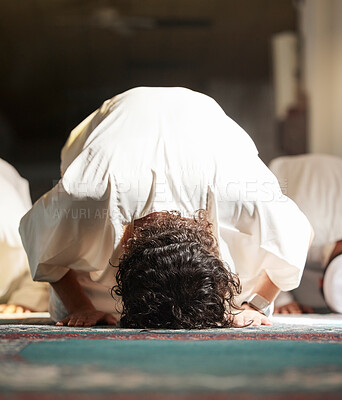 Buy stock photo Muslim, prayer and mosque with a man praying in faith or faith for fajr, dhuhr or asr, otherwise maghrib or isha'a in a group. Salah, worship or pray with islamic men in devotion for ramadan