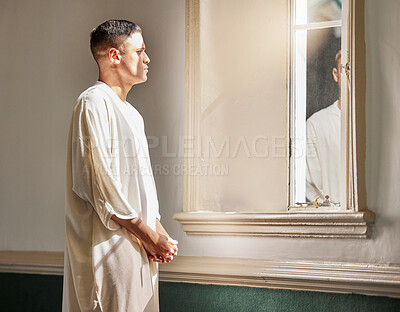Buy stock photo Prayer, reflection and muslim man in mosque with mirror in Saudi Arabia, meditation and spiritual wellness in worship. Religion, hope and culture, islamic student thinking or praying during Ramadan.