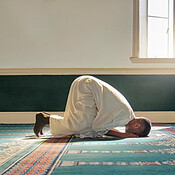 mosque-worship-and-muslim-man-in-prayer-on-his-knees-for-gratitude