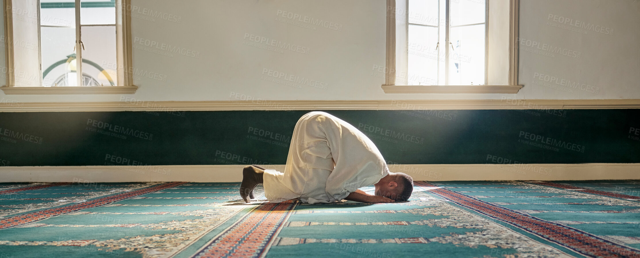 Buy stock photo Mosque, worship and muslim man in prayer on his knees for gratitude, support or ramadan for spiritual wellness. Religion, tradition and islamic guy praying or reciting quran to allah at islam temple.