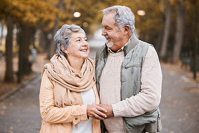 Buy stock photo Senior couple, love and hug while walking outdoor for exercise, happiness and care at a park in nature for wellness. Old man and woman together in a healthy marriage during retirement with freedom