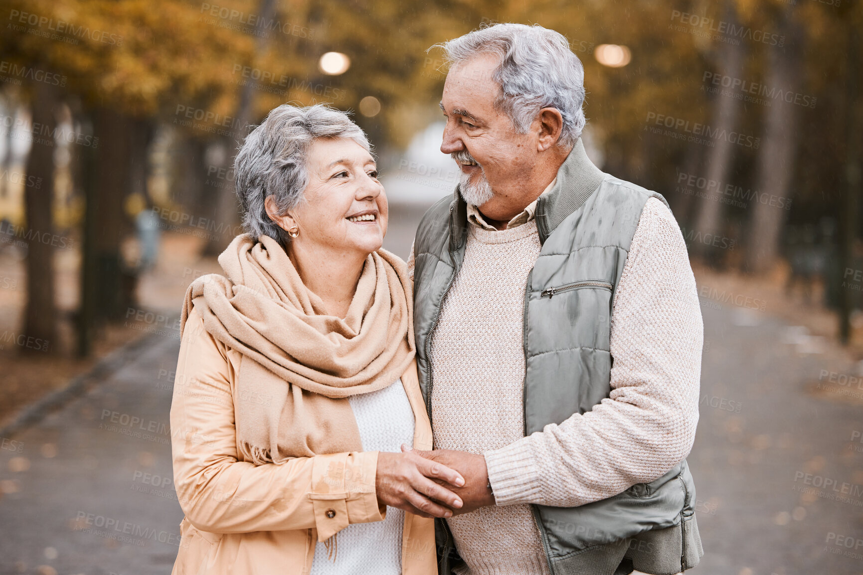 Buy stock photo Senior couple, love and hug while walking outdoor for exercise, happiness and care at a park in nature for wellness. Old man and woman together in a healthy marriage during retirement with freedom