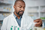 Pharmacy, pharmacist and black man check inventory on shelf in shop. Wellness, healthcare products and male medical professional checking stock for medicine, medication boxes or pills in drug store.
