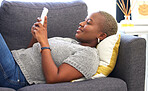 Social media, relax and black woman with a phone for communication, mobile chat and app on the sofa. Connection, internet and calm African girl with a mobile for online conversation on the couch