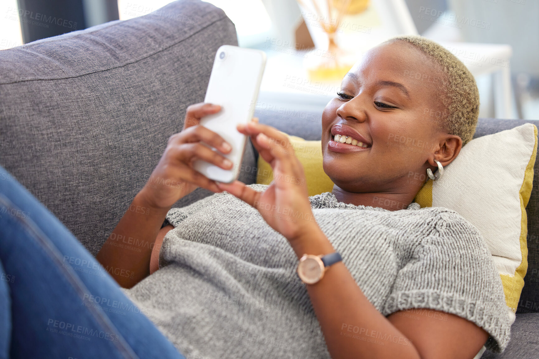 Buy stock photo Social media, relax and black woman with a phone for communication, mobile chat and app on the sofa. Connection, internet and calm African girl with a mobile for online conversation on the couch