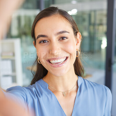 Buy stock photo Happy, portrait or business woman taking a selfie in office building for a social media profile picture and smiles with pride. Face, photo or manager with goals, success mindset or motivation to work