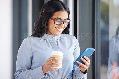 Buy stock photo Coffee, phone and business woman on a break in the office networking on social media, mobile app or internet. Happy, smile and professional employee reading a blog on her cellphone in the workplace.