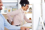 Back pain, stress or black woman in call center with a spine injury, burnout or muscle problem at office desk. Callcenter, emergency or sales agent frustrated with uncomfortable bad chair or backache