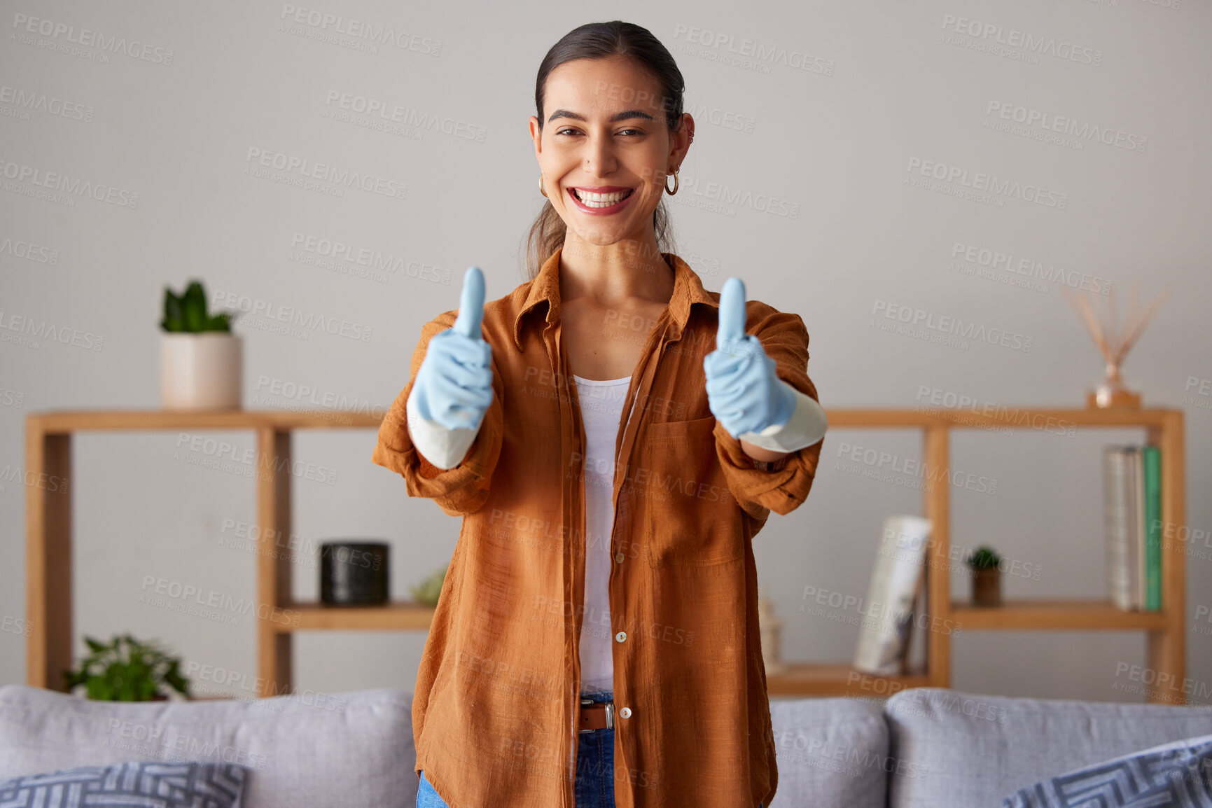 Buy stock photo Happy woman, thumbs up and cleaning service with a smile in a house or apartment living room for safety with gloves. Female cleaner showing hand sign to clean dirt, dust and bacteria at home