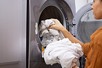 Laundry, cleaning and woman with clothes in the washing machine for housekeeping, clean fabric and home spring cleaning. Service, clean and cleaner at a laundromat for morning housework routine