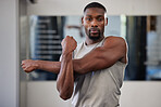 Gym portrait and black man stretching arms for bodybuilder fitness and muscle warm up with focus. Training, wellness and athlete man workout preparation for exercise lifestyle at health club.

