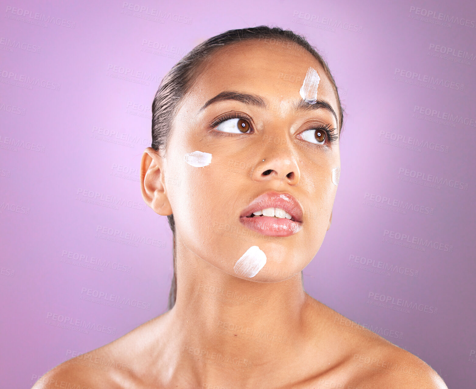 Buy stock photo Woman face, skincare and beauty cream or lotion for dermatology, health and wellness of natural glow skin on purple background. Headshot of aesthetic cosmetics model in studio with sunscreen product
