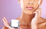 Skincare, beauty and woman with face cream product for dermatology, health and wellness mock up on a purple background. Aesthetic model in studio for self love, self care and facial spa therapy