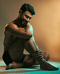 Fitness, wellness and man in neon studio with smile for exercise, bodybuilder training and workout. Beauty, skincare and male model in underwear on floor with muscles, sports goals and motivation 