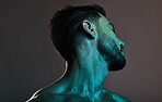 Skincare, beauty and man with neon lights in studio for cosmetics, grooming and self care treatment. Creative art, design and blue lighting on male fashion model for satisfaction, wellness and style