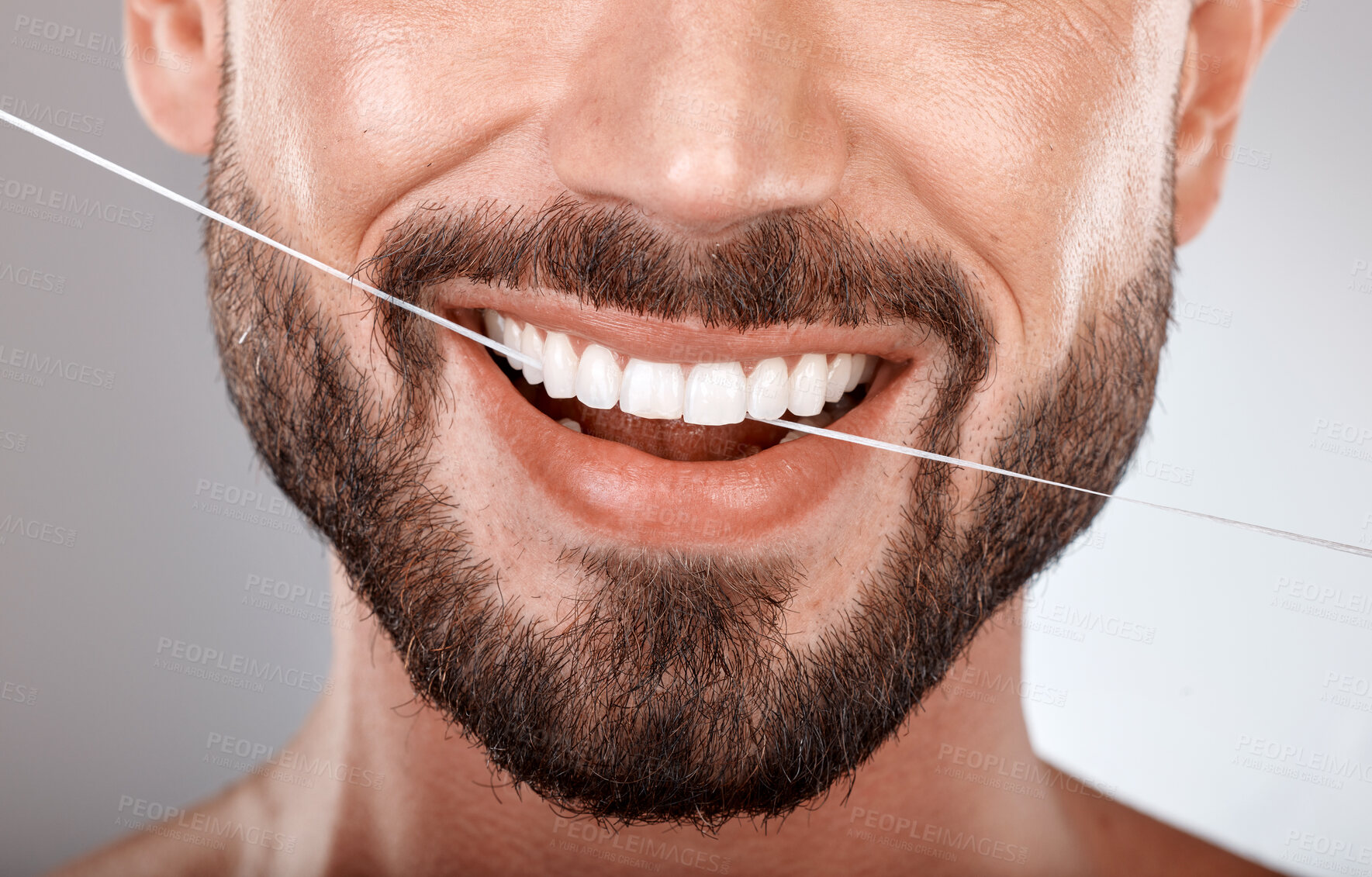 Buy stock photo Dentist, floss and mouth of man with smile on gray background in studio for wellness, healthcare and hygiene. Dental care, grooming and zoom of male model for dentistry, cleaning and flossing teeth