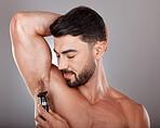 Man, razor and armpit hair for skincare wellness, hygiene grooming and natural self care cosmetics treatment in grey studio background. Model, shaving and dermatology cleaning or hair removal routine