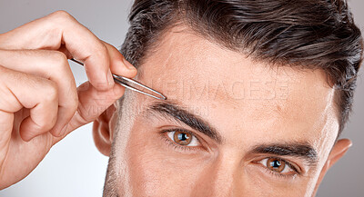 Buy stock photo Man, eyebrow tweezers and eyes portrait for hair removal, skincare beauty and grooming wellness or hygiene cleaning in grey studio background. Model, cosmetics facial care and brows microblading