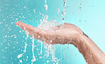 Beauty, cleaning and hand of man with water splash for self care, wellness and cosmetic campaign. Health, hygiene and shower skincare hydration model washing zoom in blue studio background.


