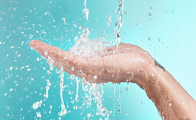 Buy stock photo Beauty, cleaning and hand of man with water splash for self care, wellness and cosmetic campaign. Health, hygiene and shower skincare hydration model washing zoom in blue studio background.

