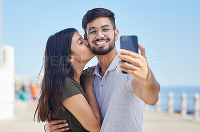 Buy stock photo Phone, kiss or couple love taking a selfie on a romantic honeymoon, beach holiday or vacation in a summer romance. Smile, profile pictures or happy man enjoys quality bonding time with Indian partner