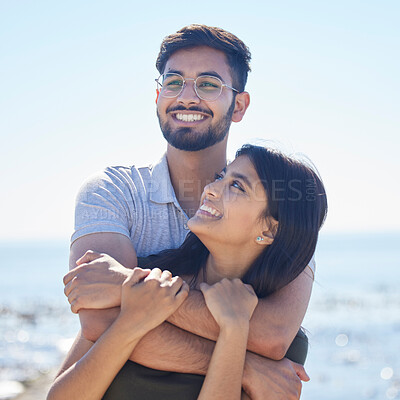 Buy stock photo Smile, hug and support with couple at beach, travel and care on summer holiday by ocean, commitment and love outdoor. Young, happy and relationship with romantic date, man and woman embrace on trip