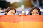 Love, pride flag and portrait of a lesbian couple at a LGBTQ, freedom or community parade in the city. Happy, celebration and interracial gay women with commitment at a LGBT, rainbow sexuality event.