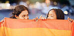 Rainbow flag, LGBTQ and happy lesbian couple with love at a freedom, pride or community parade in the city. Celebration, interracial and gay women with commitment at a LGBT sexuality event in town.