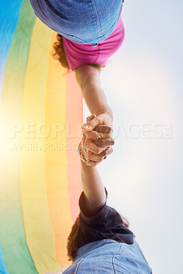 Buy stock photo LGBTQ community, rainbow flag and couple holding hands for human rights protest, solidarity and gay lesbian support. Queer, sky and black people together in love, partnership and equality below view