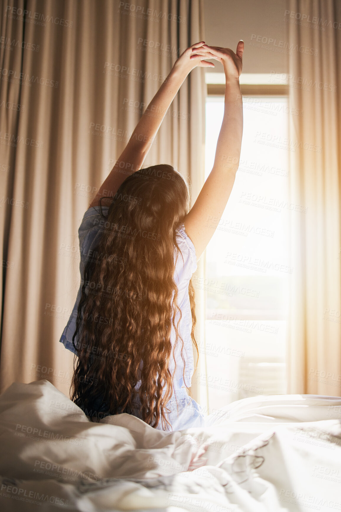 Buy stock photo Morning, wake up and a woman stretching in the bedroom of her home after sleeping or rest on the weekend. Back, bright and flare with a female sitting on a bed while waking with an early stretch