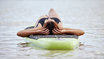 Relax, woman or surfer on water at a beach on holiday vacation resting on a surfboard in Bali. Freedom, thinking or healthy sports girl relaxing body in calm nature, sea or peaceful ocean in summer