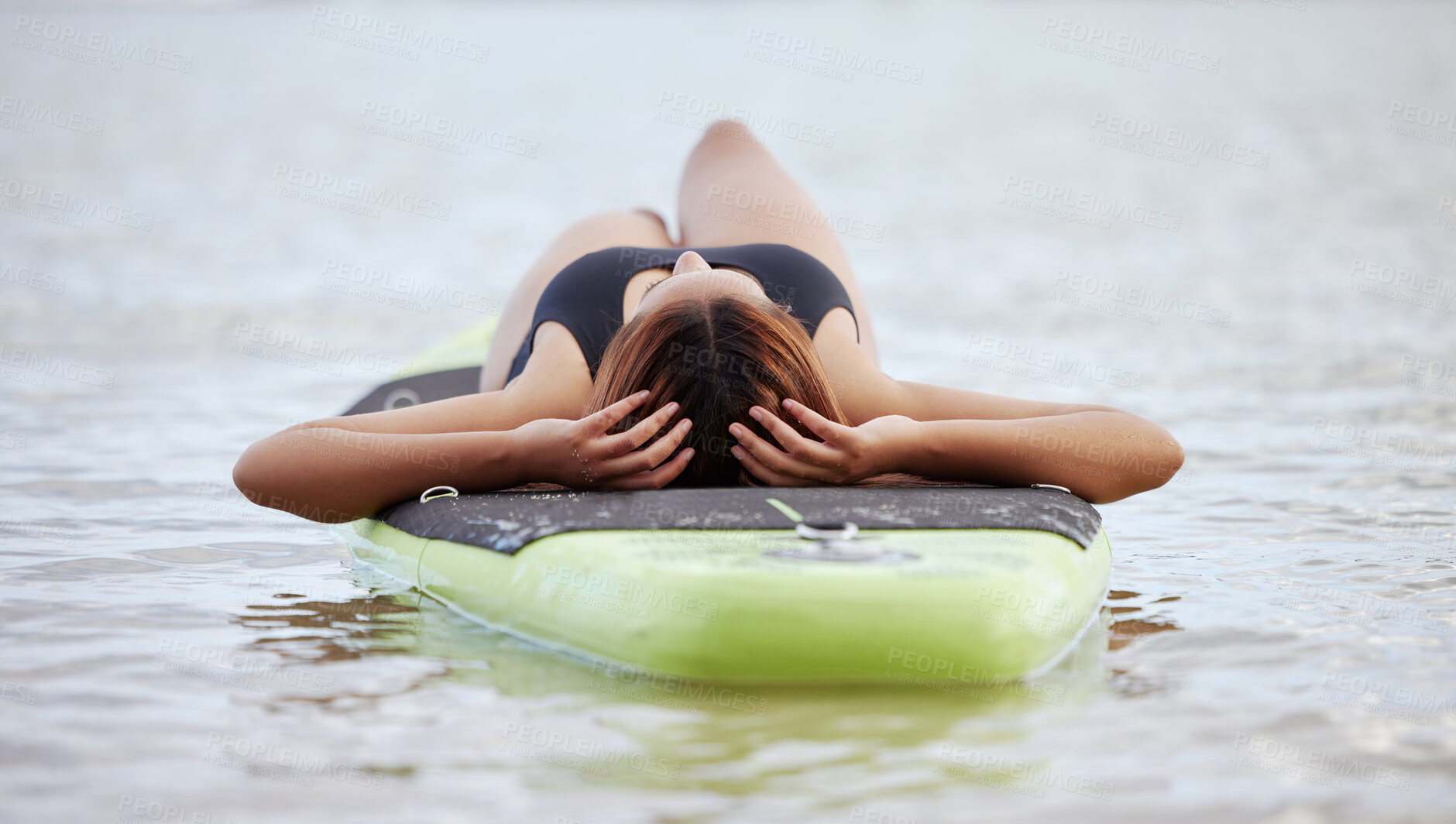 Buy stock photo Relax, woman or surfer on water at a beach on holiday vacation resting on a surfboard in Bali. Freedom, thinking or healthy sports girl relaxing body in calm nature, sea or peaceful ocean in summer