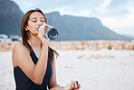 Beach, health and woman drinking water swimming in the sea while on summer vacation in Hawaii. Wellness, ocean and girl enjoying refreshing drink while relaxing on seaside holiday, trip or adventure.