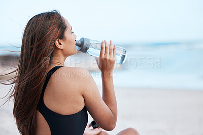 Buy stock photo Water drink, thirsty and woman at the beach to relax, holiday peace and zen at the ocean in Hawaii. Hydration, calm and girl drinking from a bottle at the sea for a travel vacation in summer