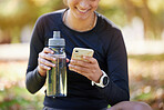 Water bottle, smartphone and woman in park for fitness  website app, blog or social media exercise, workout or training update. Healthy, nutrition and cellphone technology or gear of runner in nature