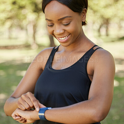 Buy stock photo Fitness, watch and runner with a sports black woman in the park for cardio exercise or endurance fitness. Health, app and training with a female athlete tracking her run or progress on a smartwatch